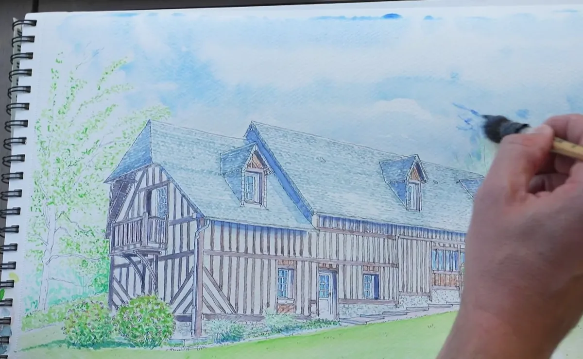 L’aquarelle presque finie : Reinette Grise sous un ciel bleu, le pinceau de Cyp encore dans les nuages